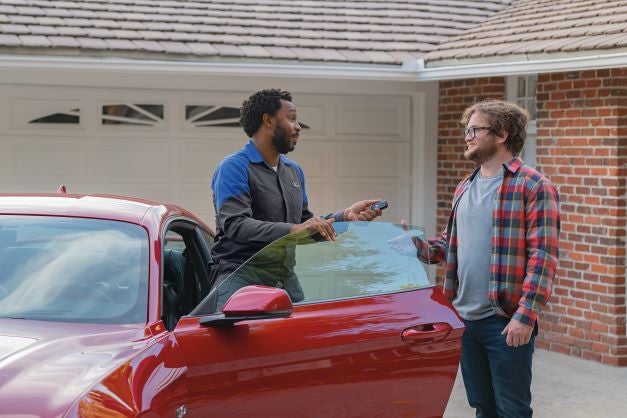 Customer in Driveway with FORD Technician